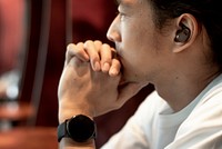 Asian man wearing a smartwatch on his wrist