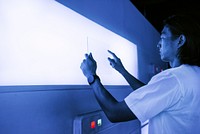 Researcher using a transparent digital tablet screen futuristic technology