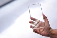 Man using a futuristic transparent smartphone