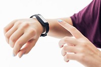 Girl with fitness tracker on her wrist pointing at the screen