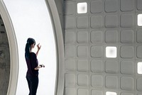 Girl using a screen in an underground tunnel