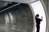 Girl connecting smartwatch to a screen in an underground tunnel