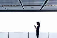 Girl standing by a large blank billboard at a shopping mall