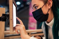 Girl selecting items to buy from a screen in a shop in the new 