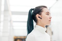 Asian girl with smart earphones technology of the future