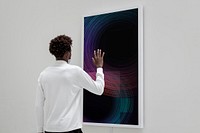 Man touching an interactive screen at a gallery