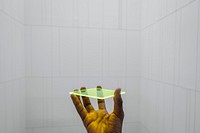 Man holding a neon yellow square glass