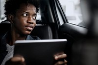 Man using a tablet in a self driving car