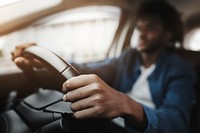 Man holding on tight to the steering wheel of a smart car