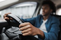 Man holding on tight to the steering wheel of a smart car