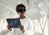 Man wearing smart glasses using a transparent tablet futuristic technology