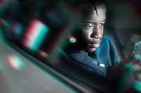 Man relaxing in the back of a self-driving car