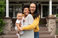 Cute diverse family standing in front of the house during covid19 lockdown
