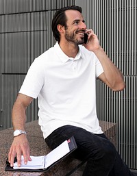 White polo shirt mockup psd man talking on the phone menswear apparel fashion