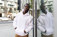 Sporty man hoodie mockup psd brown pants in the city apparel shoot