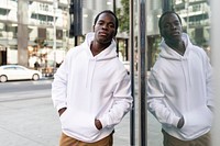 White hoodie on man with brown pants in the city