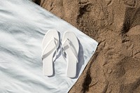 White sandals mockup psd on beach towel aerial view