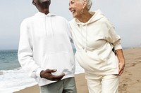 Happy senior couple relaxing at the beach in winter