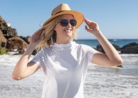 Beautiful woman in panama hat chilling at the beach