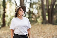 Woman in white t-shirt appreciating the beauty of the forest