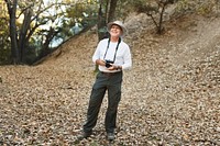 Retired man appreciating the beauty of forest