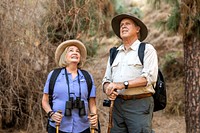 Happy elderly couple enjoying nature in the Californian forest