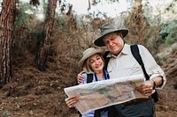 Lovely senior couple using a map to search for direction