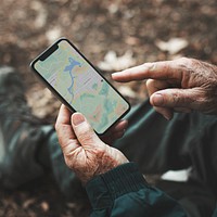 Senior man using GPS navigation on his smartphone