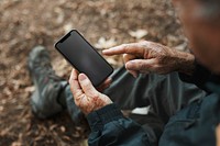 Smartphone black screen mockup psd with senior man holding it