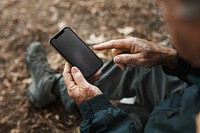 Senior man holding smartphone with black screen