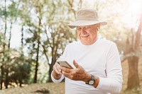 Modern grandpa enjoying his digital gadgets in nature