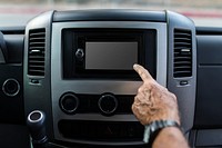 Finger pressing on black touch screen car stereo