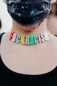 Protester wearing a Fuck Racism necklace at the Black Lives Matter protest in downtown Los Angeles.  8 JUL, 2020, LOS ANGELES, USA