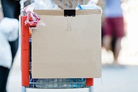 Brown cardboard with copy space clipped on a shopping cart 