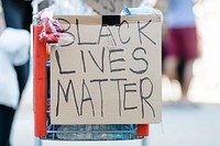 Black lives matter on a cardboard clipped on a shopping cart 