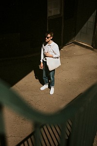 Man with eco bag in town dark tone