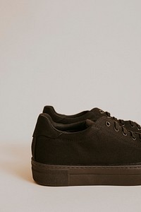 Woman's black canvas sneaker on gray