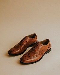 Men's brown leather derby shoes on beige