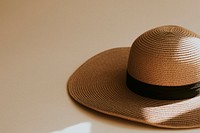 Wide brim straw hat on beige