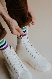 Man hands tying shoelaces white sneaker