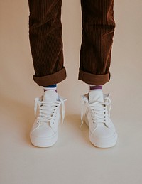White sneakers with untied laces on man model