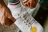 Man tying shoelaces on canvas sneaker mockup