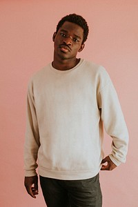 African American man wearing white sweater mockup on pink background