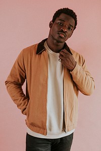 Black man in brown jacket mockup on pink background studio shot