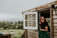 Cheerful woman in a rural wooden house
