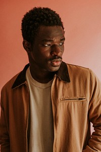 Black man in brown jacket mockup on pink background studio shot