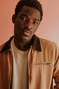 Black man in brown jacket mockup on pink background studio shot