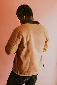 Black man in brown jacket mockup on pink background studio shot