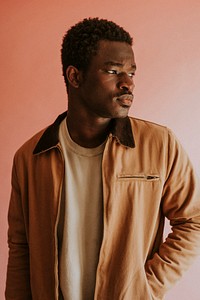 Black man in brown jacket mockup on pink background studio shot