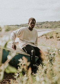 Model in outdoor apparel shoot on a boat by the coast